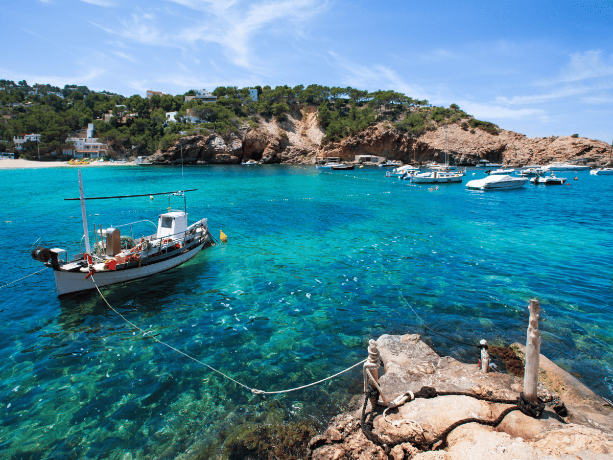 Cala Vadella Ibiza bay with blue water with Tubber boats