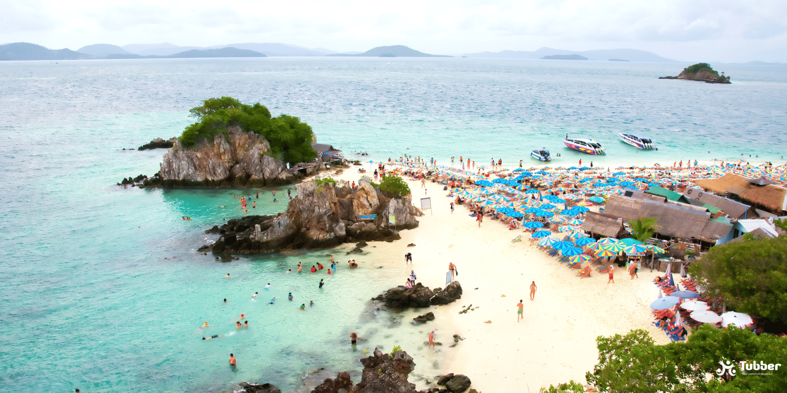 Koh Khai beach in Thailand with colorfull umbrellas, tourists and crystal clear water.