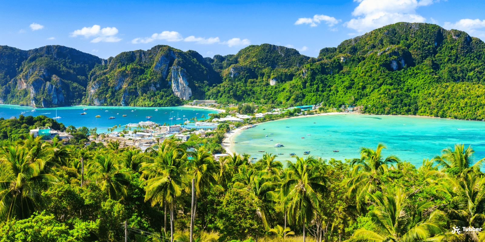 Scenic view of Koh Phi Phi Don, lush cliffs, turquoise bays, anchores boats in tropical paradise