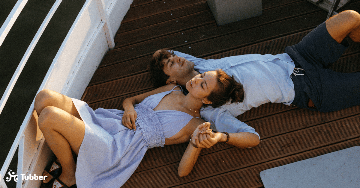 A couple laying on the deck of a yacht relaxing and sleeping in the sun light