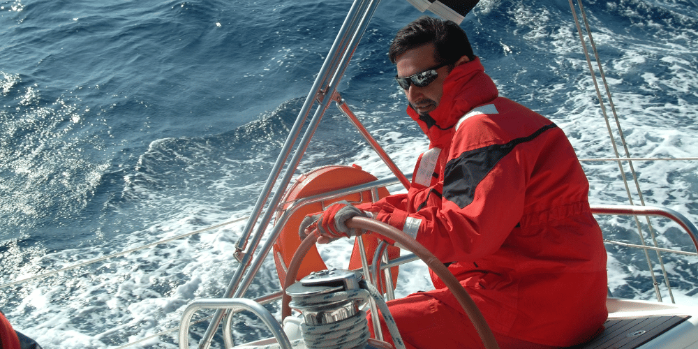 A skipper steers a yacht