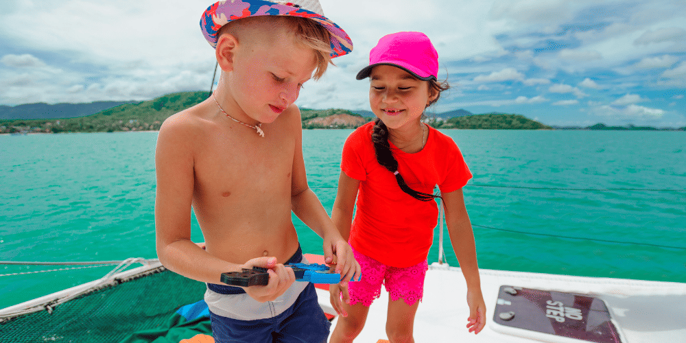 Two kids playing on sailing yacht