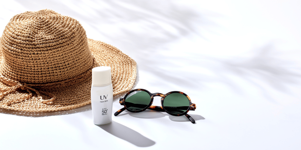 Sun hat and sunglasses on a beach
