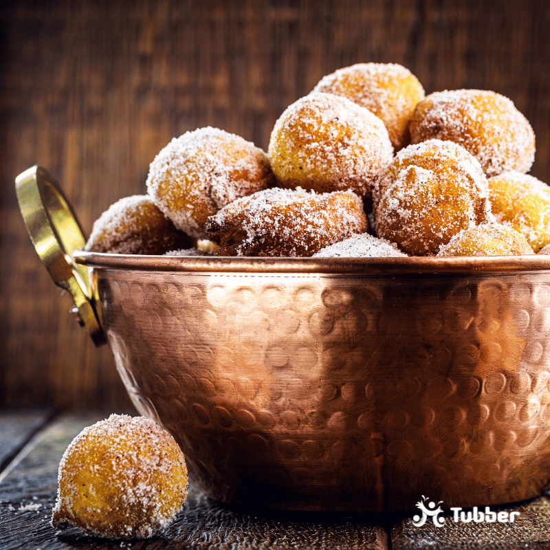 Homemade dumplings in antique copper pot, Traditional Croatian cookies called Fritule