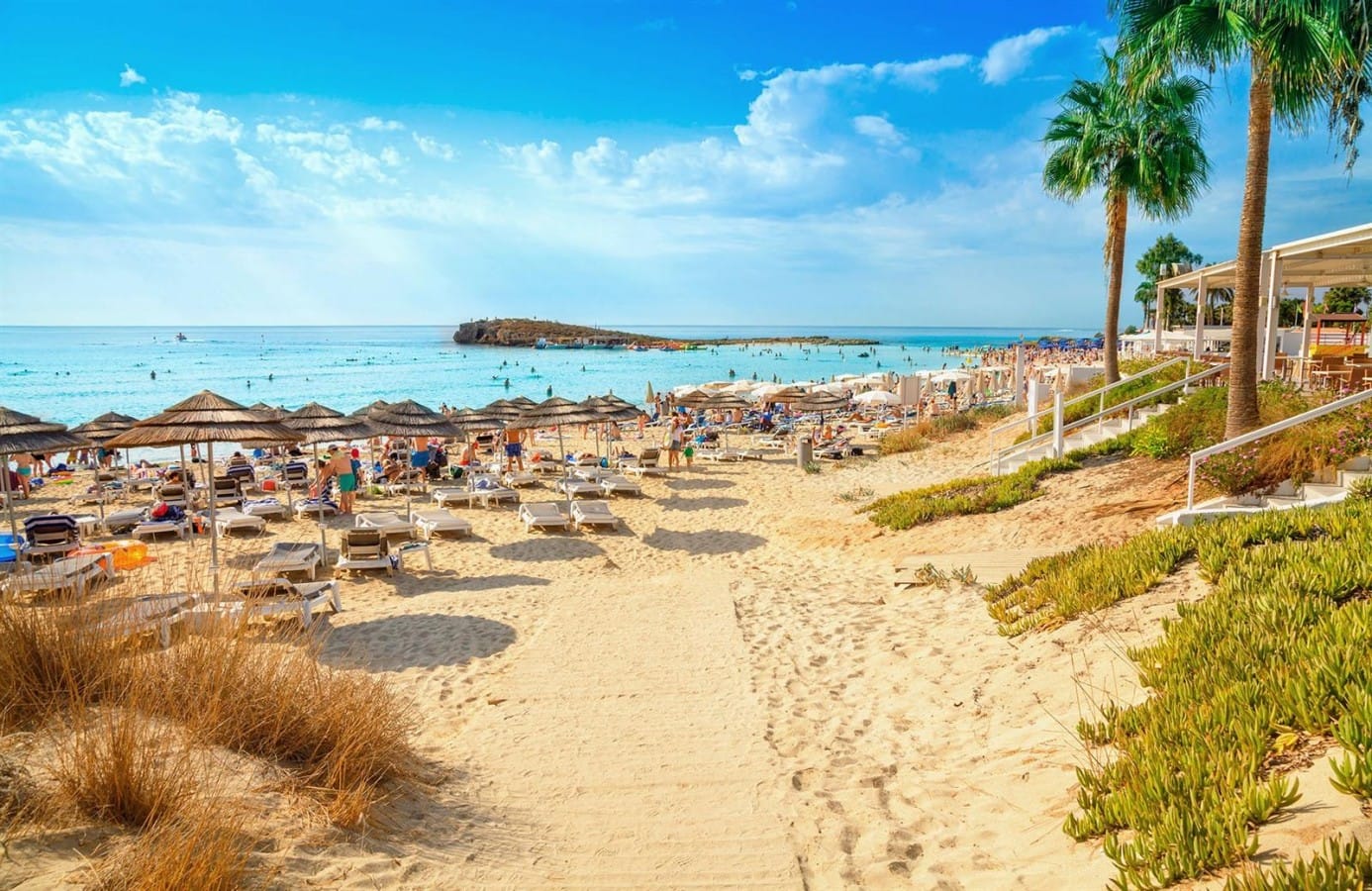 Ayia Napa in Cyprus with a lot of people enjoying the sun at the beach.