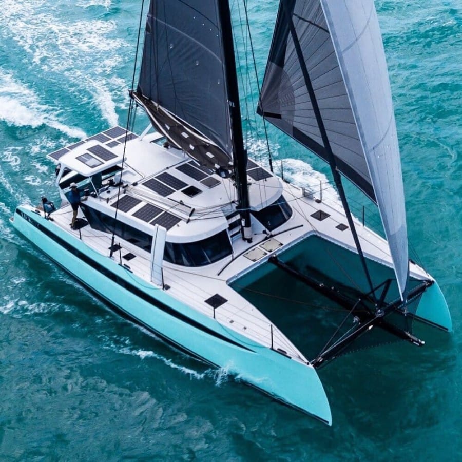 Catamaran cruising on the ocean blue water.