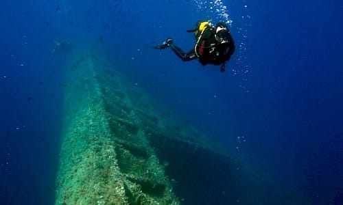 A professional diving in the Fish Farm on Formentera.